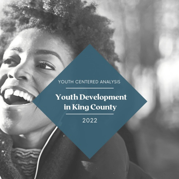 image is of B&W young Black person smiling, with a blue diamond on top that reads youth development in king county