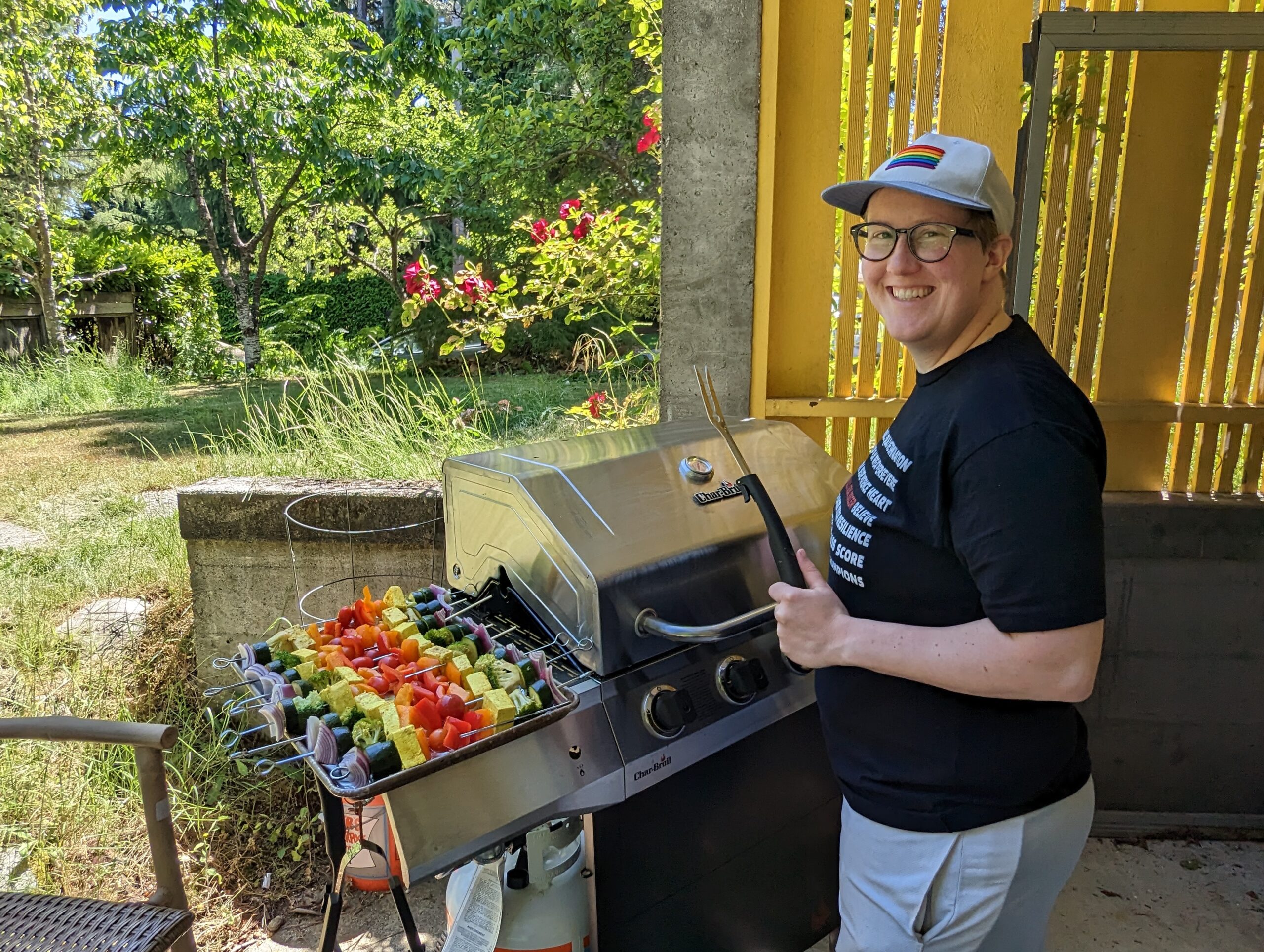 image is of CiCi, grilling rainbow colored kebabs!